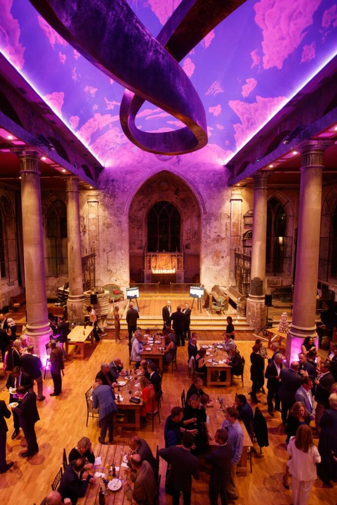 Ariel shot of a bronze ceiling sculpture with people sat at tables and eating