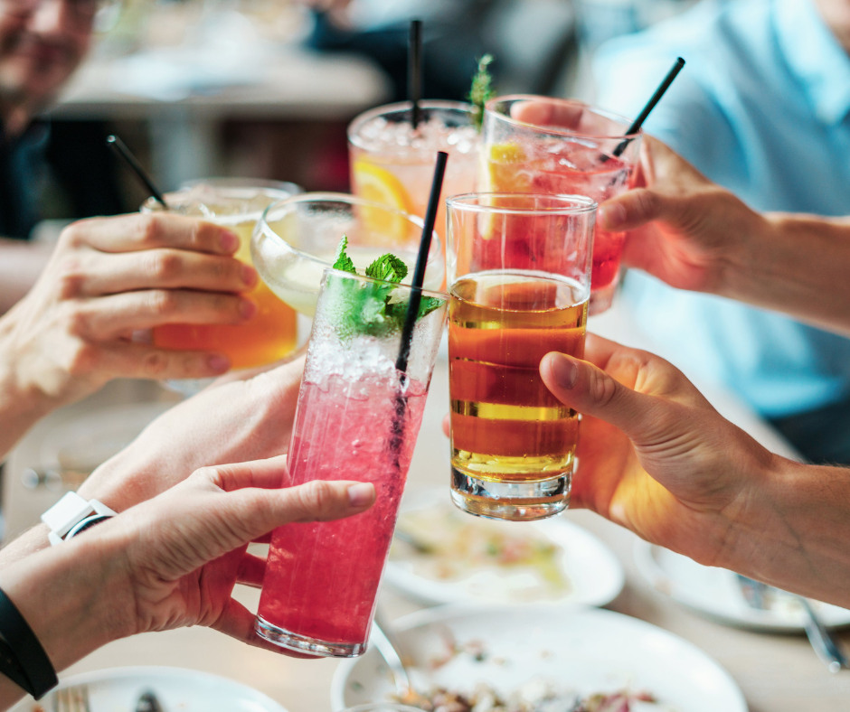 A group of people cheersing with drinks