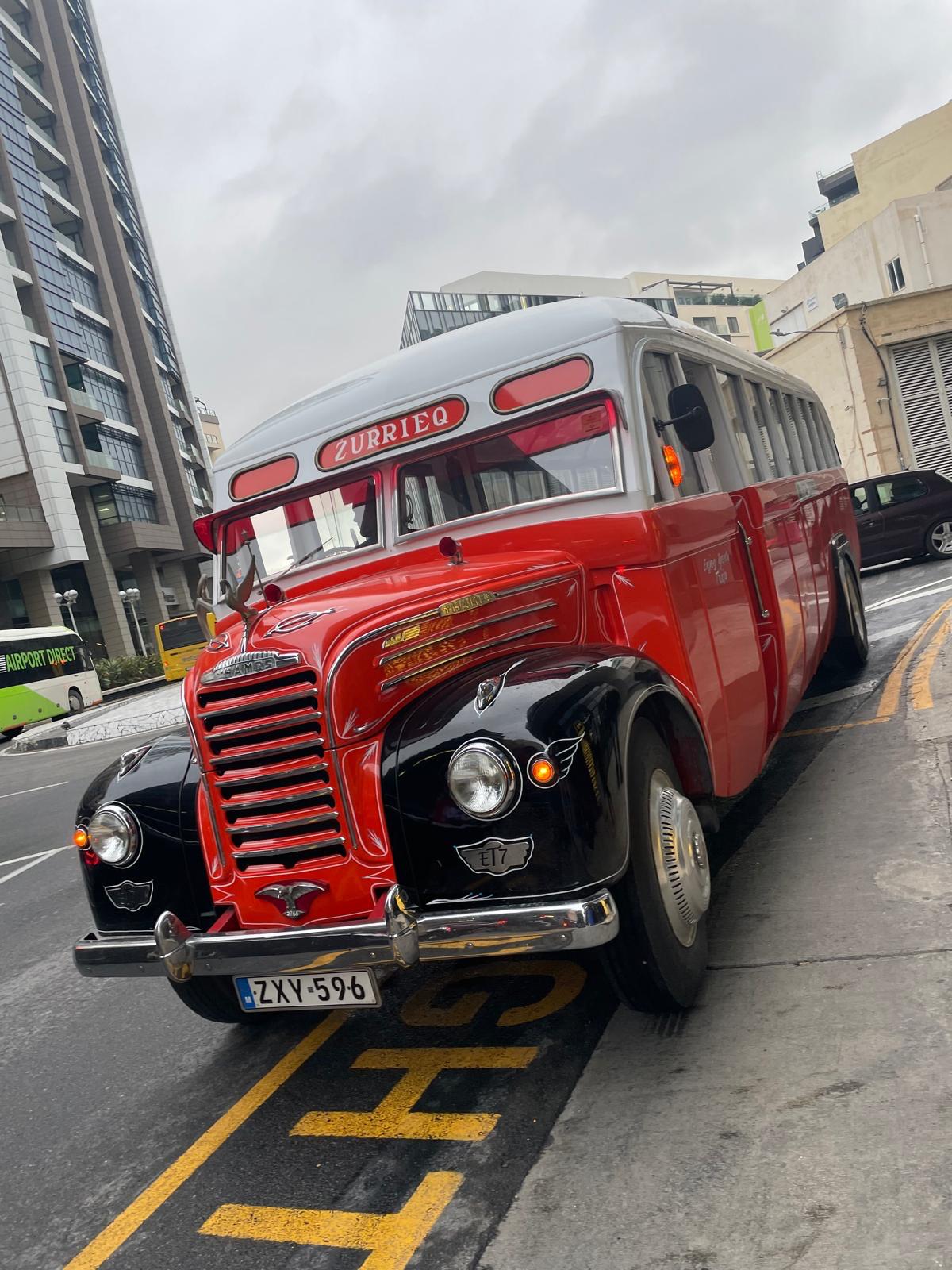 Vintage bus which has red and white livery